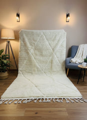 Beige Moroccan wool rug displayed vertically showing diamond design and tassel edges