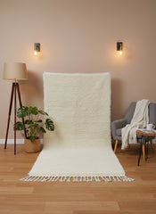 Itriwan beige rug displayed upright with soft texture and tassel edges