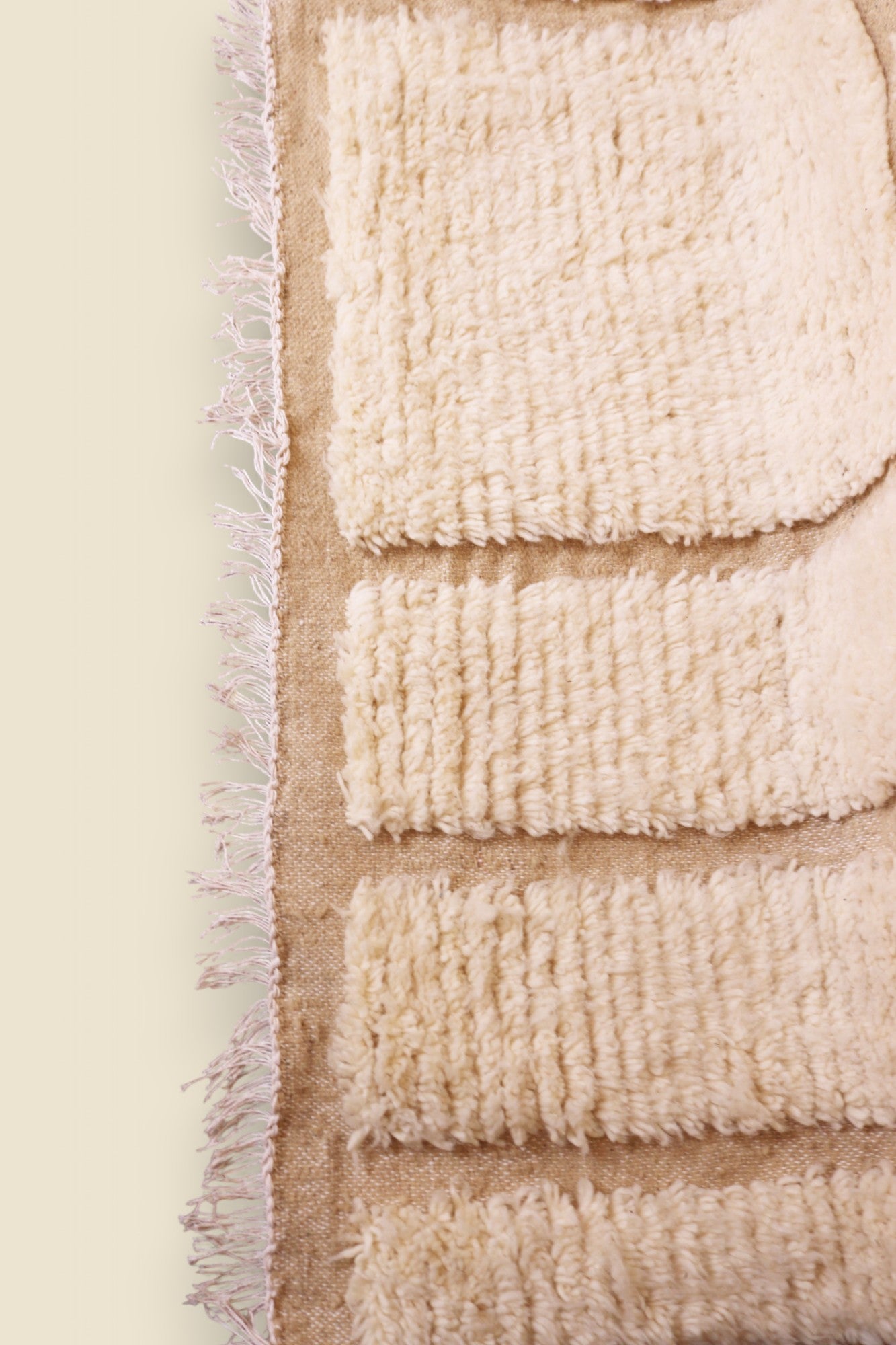 Close-up of cream wool texture and fringe on Ayla Berber Moroccan rug