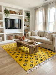 Yellow Berber wool rug under a wooden coffee table in a cozy living room
