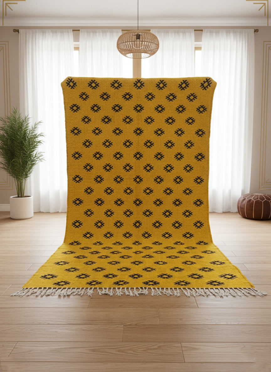 Yellow Berber Tilouin rug shown upright highlighting its black motifs.
