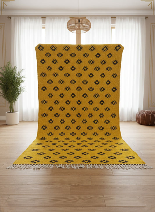 Yellow Berber Tilouin rug shown upright highlighting its black motifs.